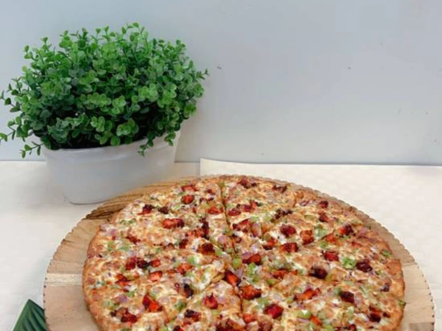 Specialty loaded pizza with generous toppings at New Pizza Factory in southeast Edmonton